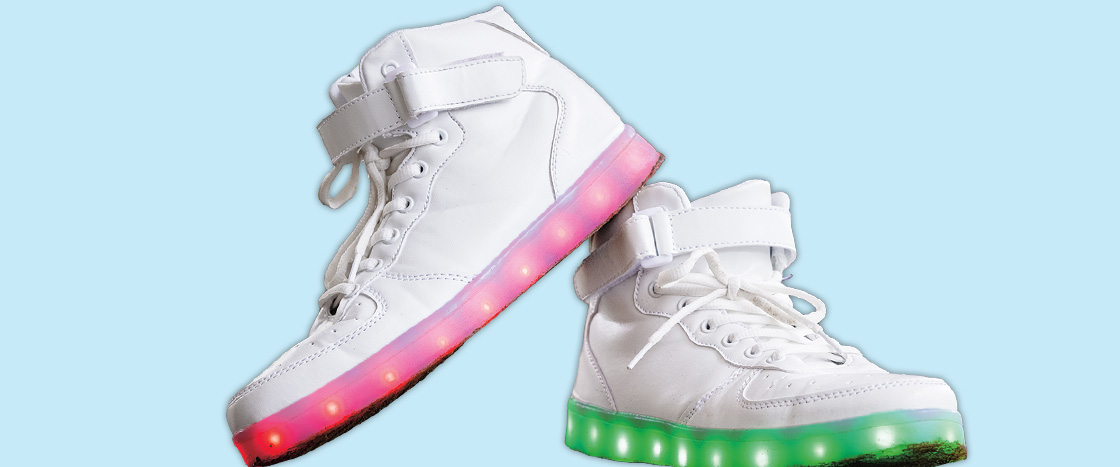 Image of white sneakers with pink & green light up bottoms