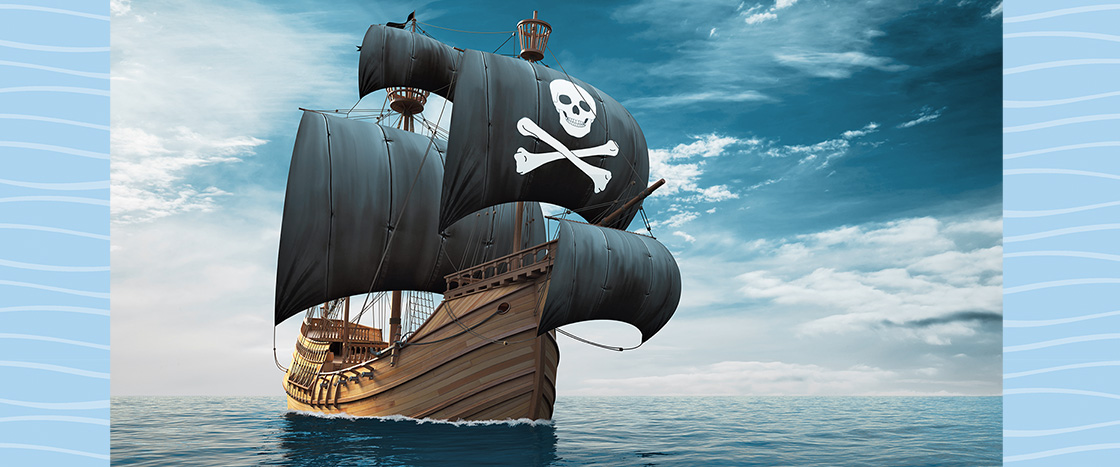 Image of a sailing pirate ship with skull and crossbones on the sails