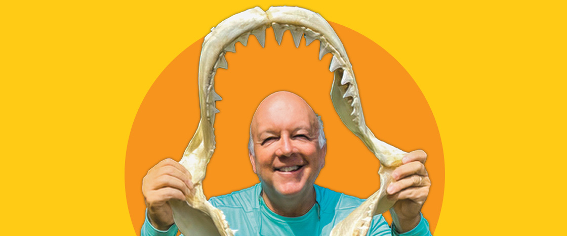 Image of an author holding a shark&apos;s jaw